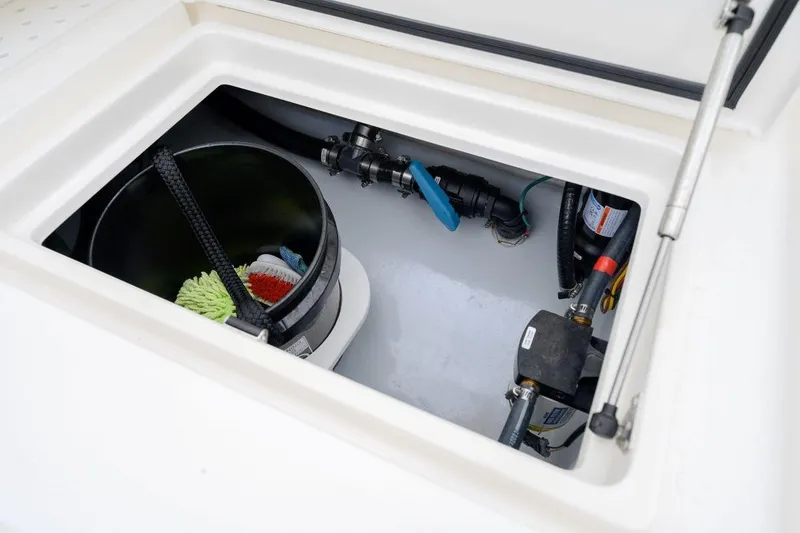 Slide: The Image of Storage compartment in 2024 SeaVee 370Z boat, featuring cleaning supplies and equipment. - 25
