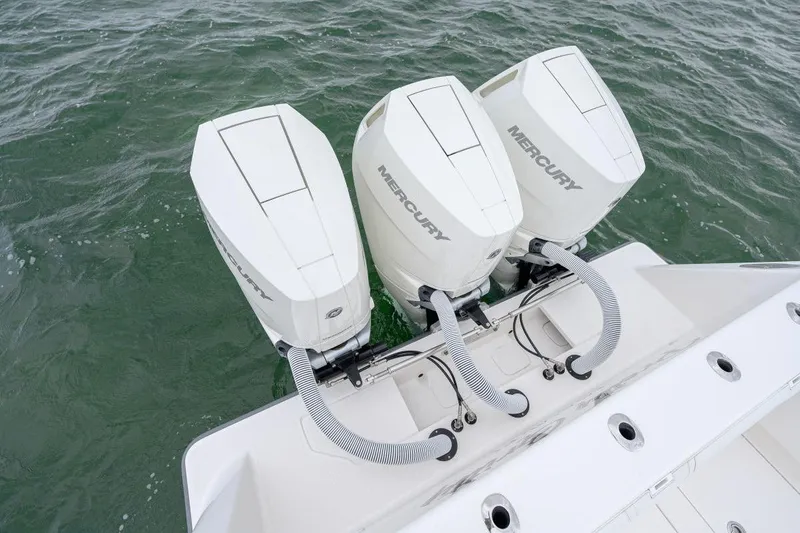 Slide: The Image of Triple Mercury outboard engines on a 2024 SeaVee 370Z boat in water. - 26