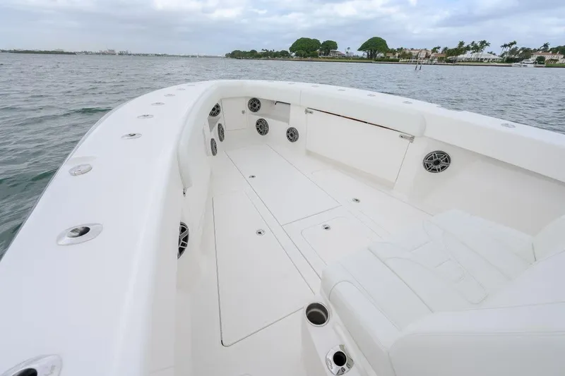 Slide: The Image of 2024 SeaVee 370Z boat deck with spacious seating and sleek design on calm waters. - 6