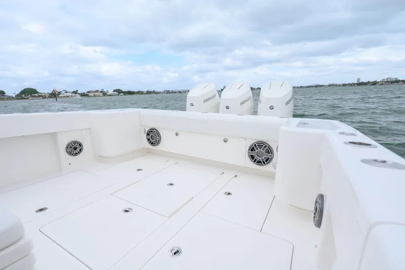 Slide: The Image of 2024 SeaVee 370Z boat deck with triple Mercury engines on open water. - 8