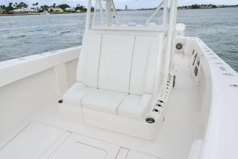 Slide: The Image of 2024 SeaVee 370Z boat interior with white seating, cup holders, and ocean view. - 9