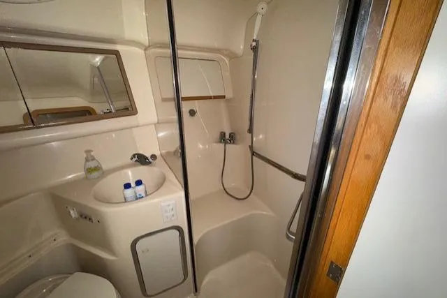Slide: The Image of Interior cabin of 1996 Sea Ray 400 Sedan Bridge with cozy seating and floral cushions. - 10