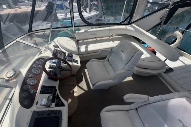 Slide: The Image of Control panel of a 1996 Sea Ray 400 Sedan Bridge with communication equipment and safety stickers. - 17