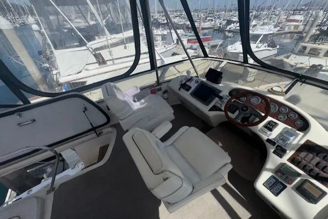 Slide: The Image of Control panel of a 1996 Sea Ray 400 Sedan Bridge yacht with switches and displays. - 18