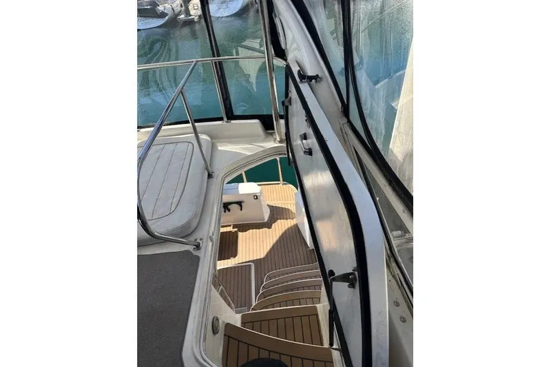 Slide: The Image of 1996 Sea Ray 400 Sedan Bridge helm view overlooking marina with numerous docked boats. - 22