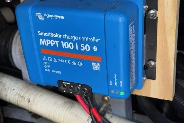 Slide: The Image of Engine room of a 1996 Sea Ray 400 Sedan Bridge with visible batteries and wiring. - 25