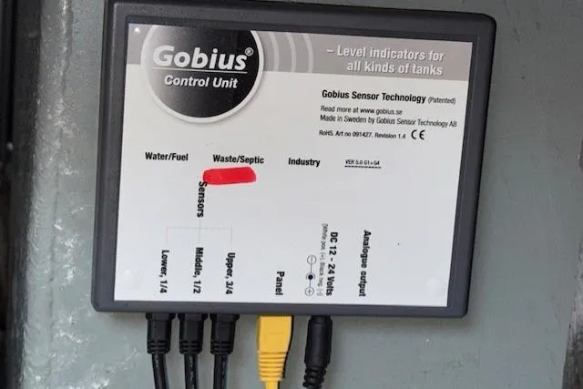 Slide: The Image of Engine room of a 1996 Sea Ray 400 Sedan Bridge with visible battery and wiring. - 26