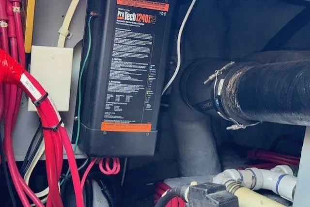 Slide: The Image of Engine room of 1996 Sea Ray 400 Sedan Bridge with fire extinguisher and mechanical components. - 29