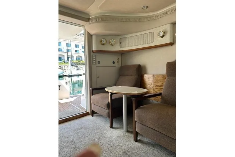 Slide: The Image of Interior of 1996 Sea Ray 400 Sedan Bridge with cozy seating area. - 3