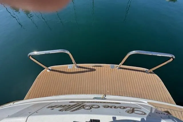 Slide: The Image of 1996 Sea Ray 400 Sedan Bridge yacht docked at marina, featuring spacious deck area. - 36