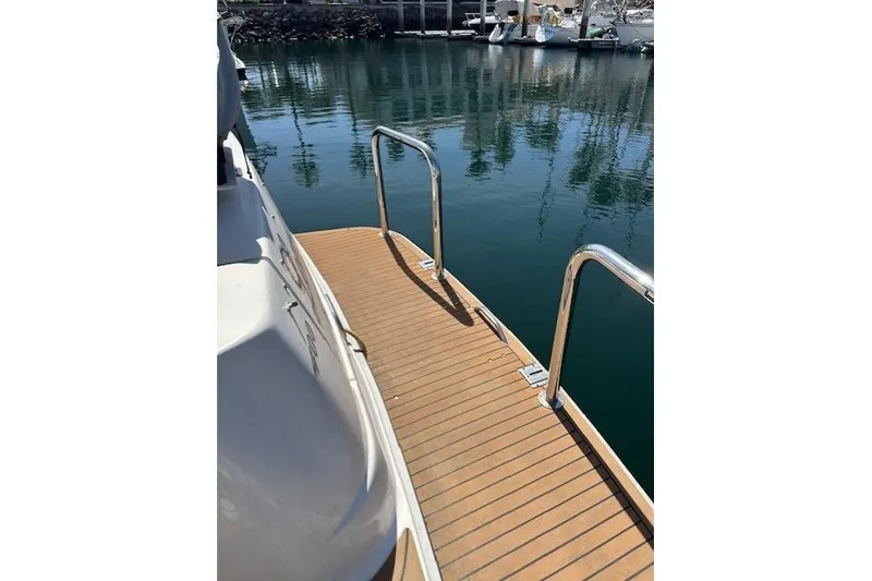 Slide: The Image of 1996 Sea Ray 400 Sedan Bridge yacht with a grill on the deck, docked at a marina. - 37