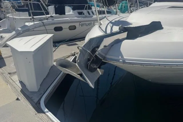 Slide: The Image of 1996 Sea Ray 400 Sedan Bridge swim platform with stainless steel rails, docked on calm water. - 38