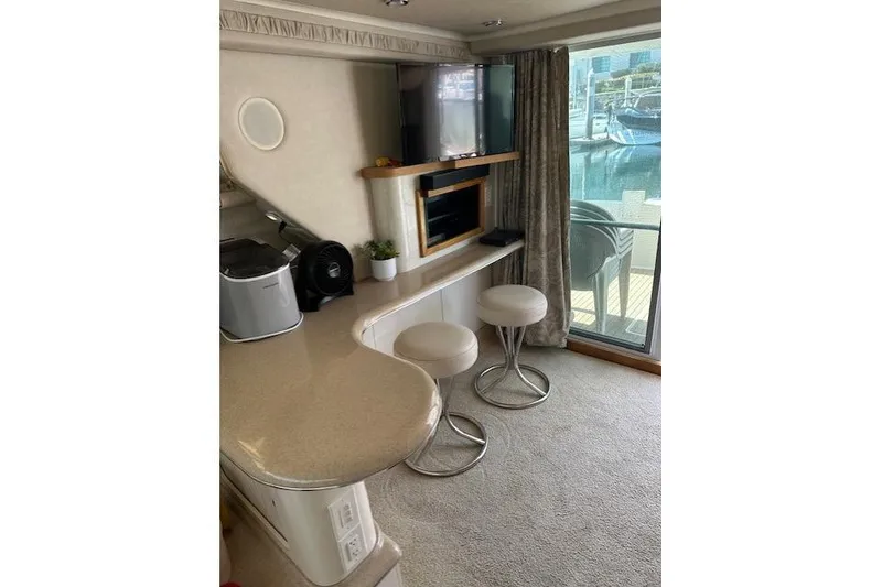 Slide: The Image of Interior of 1996 Sea Ray 400 Sedan Bridge with cozy seating and table. - 4