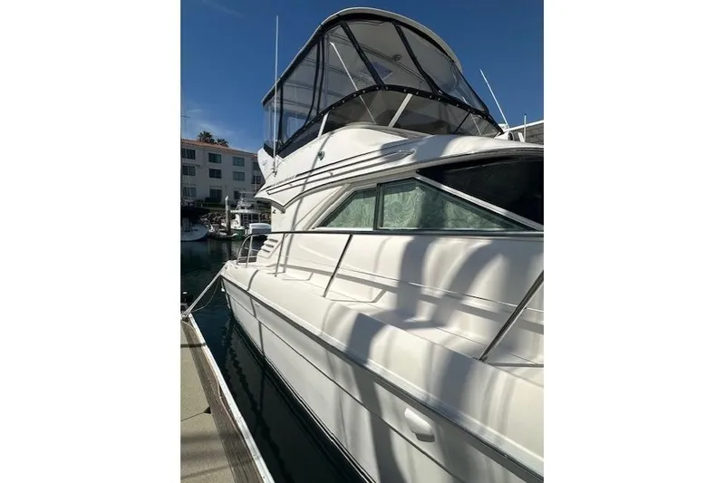 Slide: The Image of 1996 Sea Ray 400 Sedan Bridge yacht docked in marina, side view. - 43