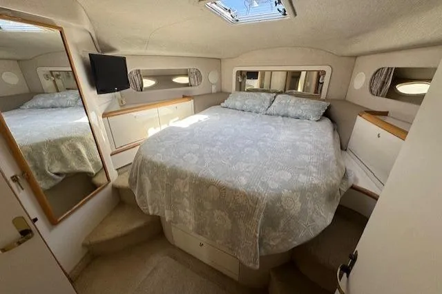 Slide: The Image of Interior of 1996 Sea Ray 400 Sedan Bridge with bar stools and TV, overlooking marina. - 5