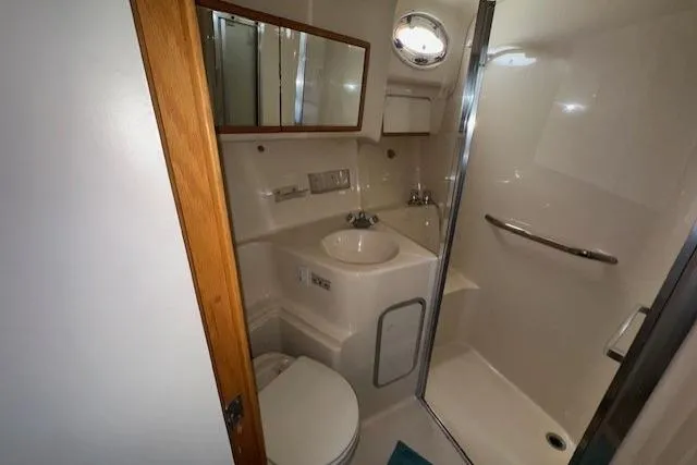 Slide: The Image of Cozy bedroom interior of 1996 Sea Ray 400 Sedan Bridge yacht with skylight and TV. - 7