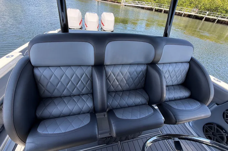 Slide: The Image of Luxurious seating on 2018 Nor-Tech 390 Sport Center Console boat, featuring quilted upholstery. - 15