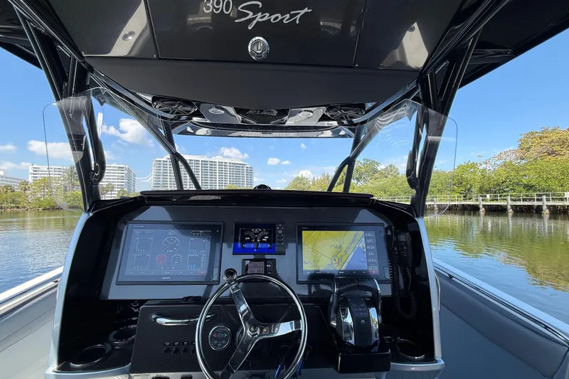Slide: The Image of 2018 Nor-Tech 390 Sport Center Console dashboard with navigation screens and steering wheel. - 16