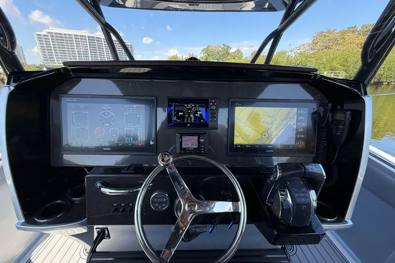 Slide: The Image of 2018 Nor-Tech 390 Sport Center Console dashboard with advanced navigation and control systems. - 17