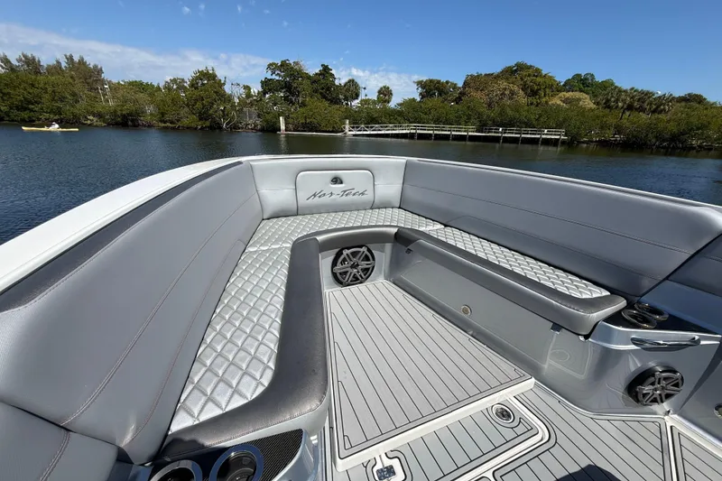 Slide: The Image of 2018 Nor-Tech 390 Sport Center Console boat interior with luxurious seating and sleek design. - 21