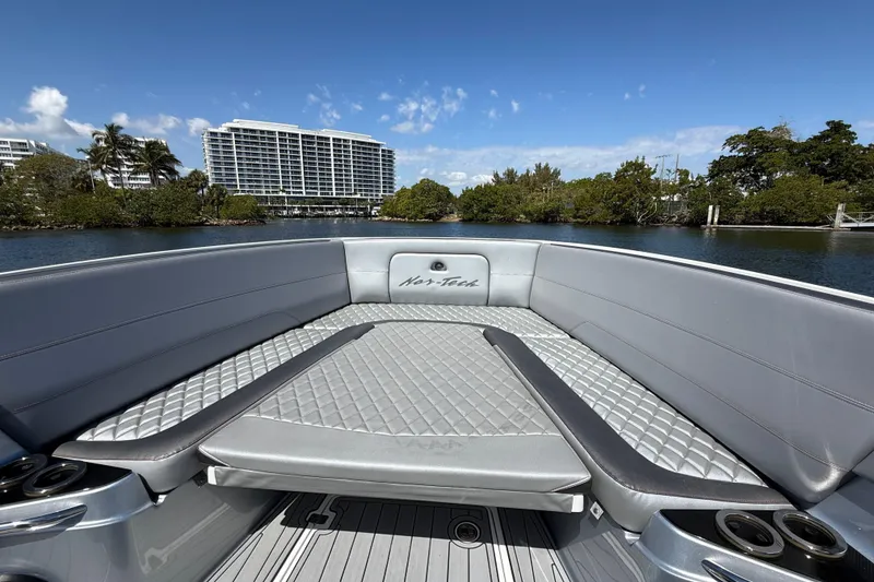 Slide: The Image of 2018 Nor-Tech 390 Sport Center Console boat interior with luxurious seating and scenic water view. - 22