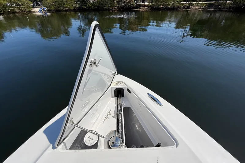 Slide: The Image of 2018 Nor-Tech 390 Sport Center Console anchor compartment open on calm water. - 24