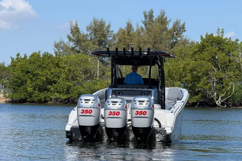 Slide: The Image of 2018 Nor-Tech 390 Sport Center Console boat with triple 350 horsepower engines on water. - 6
