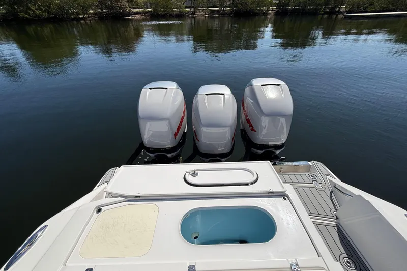 Slide: The Image of 2018 Nor-Tech 390 Sport Center Console with triple Mercury outboard engines on calm water. - 8