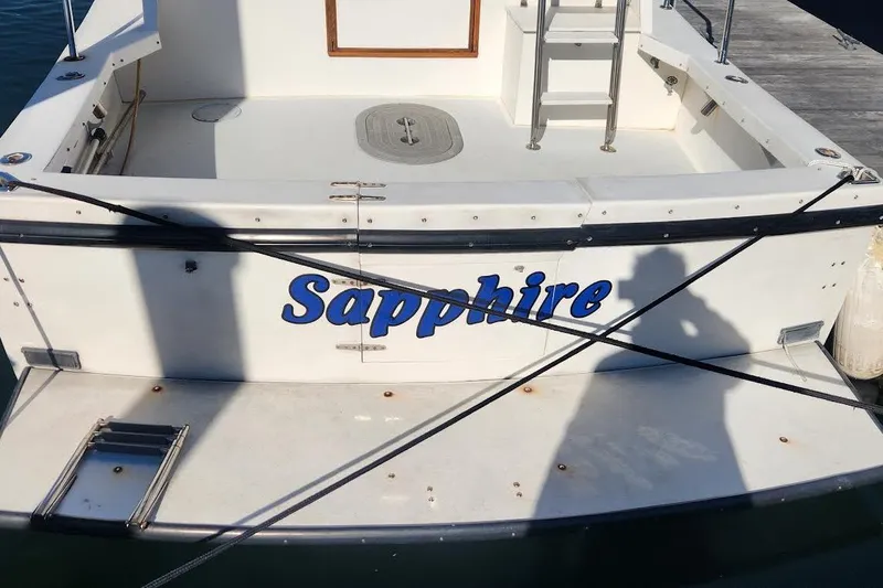 Slide: The Image of 2001 Eastern 31 Casco Bay Flybridge boat named "Sapphire" docked at a marina. - 4