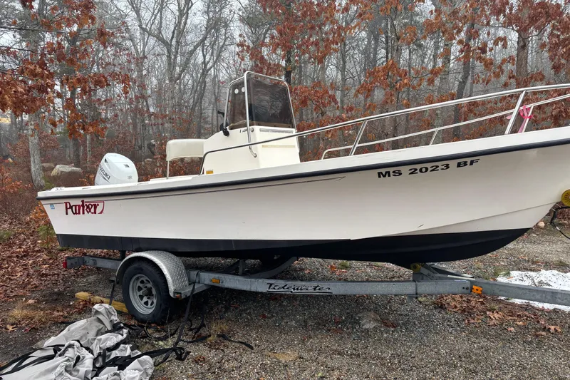 Slide: The Image of 1998 Parker 1801 Center Console boat on trailer, surrounded by autumn trees. - 3