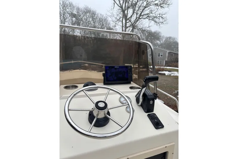 Slide: The Image of 1998 Parker 1801 Center Console boat helm with steering wheel and controls. - 4