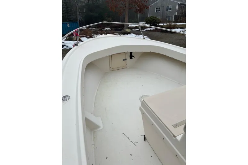 Slide: The Image of 1998 Parker 1801 Center Console boat interior with white deck and storage compartment. - 6