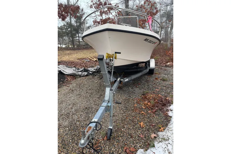 Slide: The Image of 1998 Parker 1801 Center Console boat on trailer, parked outdoors in autumn setting. - 7