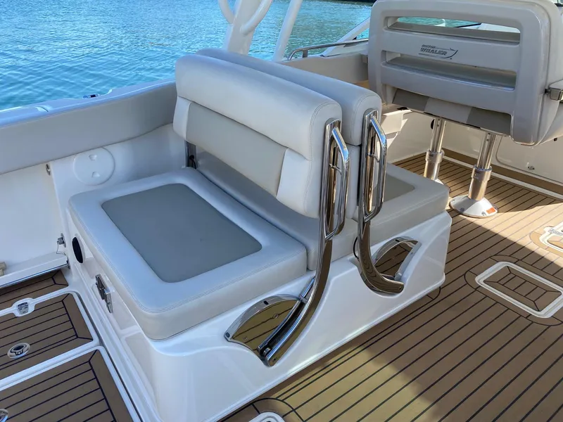 Slide: The Image of Boston Whaler 320 Vantage 2019, luxurious boat seating by the water. - 11
