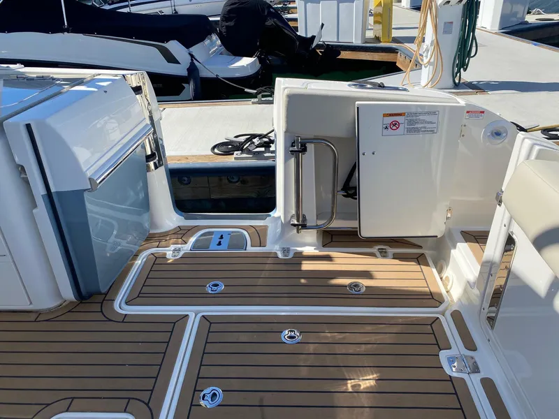 Slide: The Image of Interior of a 2019 Boston Whaler 320 Vantage boat with wooden flooring. - 15