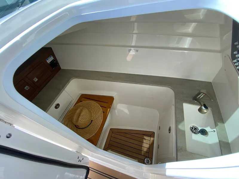 Slide: The Image of Interior of 2019 Boston Whaler 320 Vantage with sink and wood accents. - 27