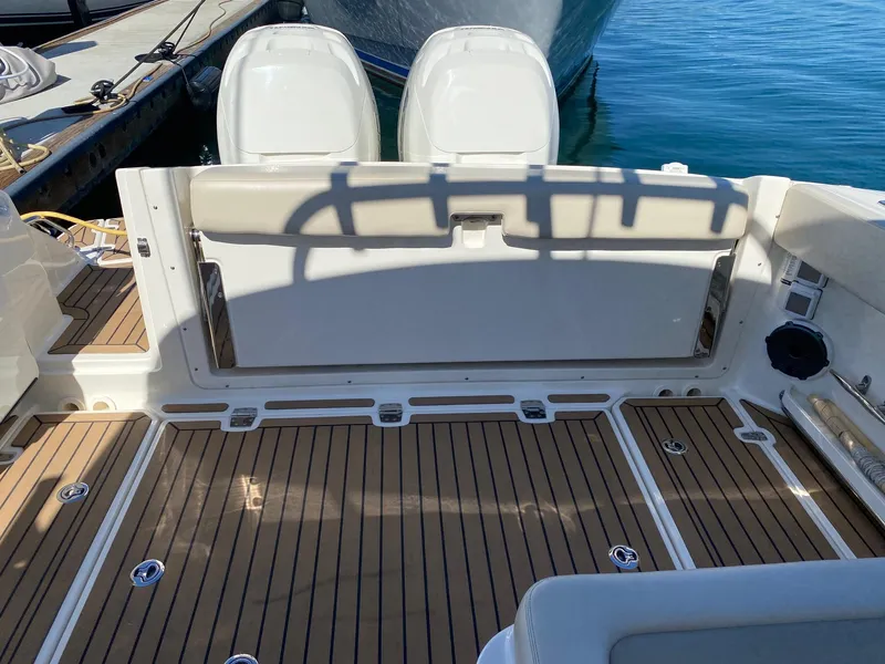 Slide: The Image of 2019 Boston Whaler 320 Vantage with teak flooring and dual engines. - 5