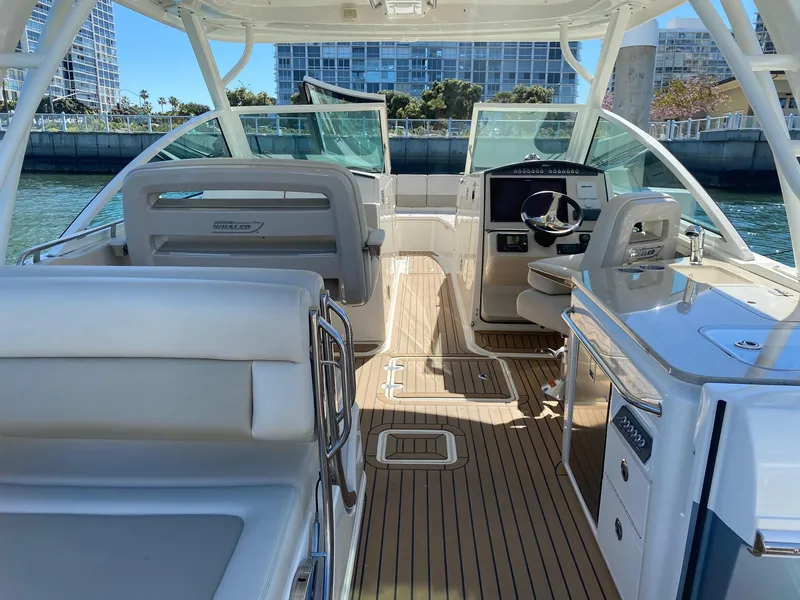 Slide: The Image of Interior view of a 2019 Boston Whaler 320 Vantage boat by the water. - 7