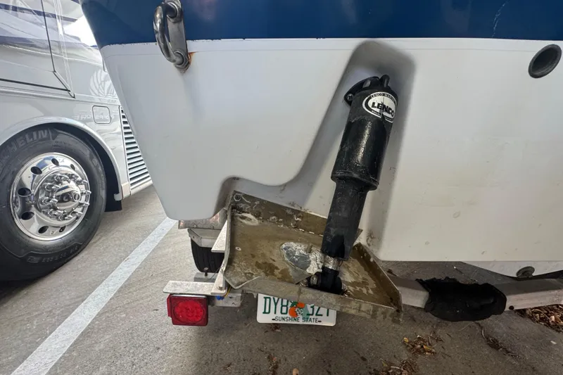 Slide: The Image of Rear view of a 2023 Wellcraft 242 Fisherman boat with trim tab and trailer. - 12