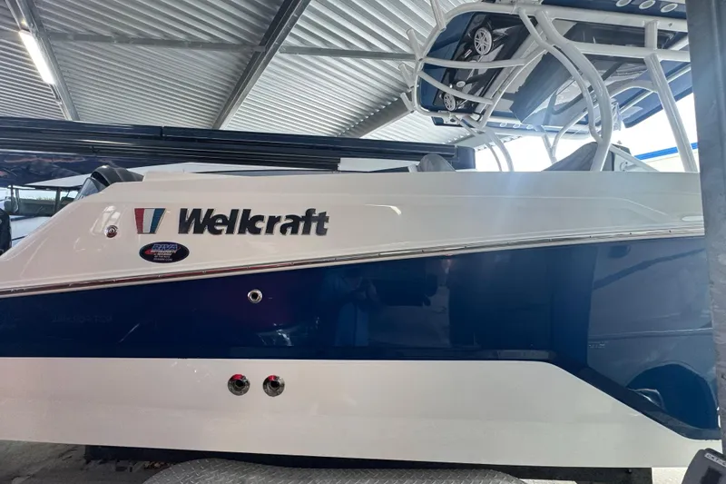 Slide: The Image of 2023 Wellcraft 242 Fisherman boat in a covered storage area. - 17