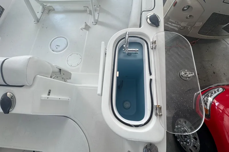 Slide: The Image of 2023 Wellcraft 242 Fisherman boat interior with livewell and seating area. - 23