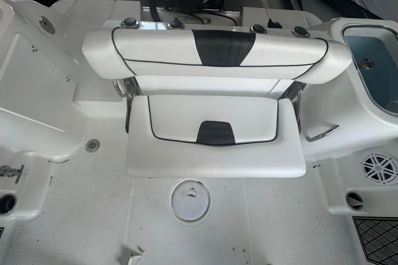 Slide: The Image of 2023 Wellcraft 242 Fisherman boat interior with white seating and storage compartments. - 26