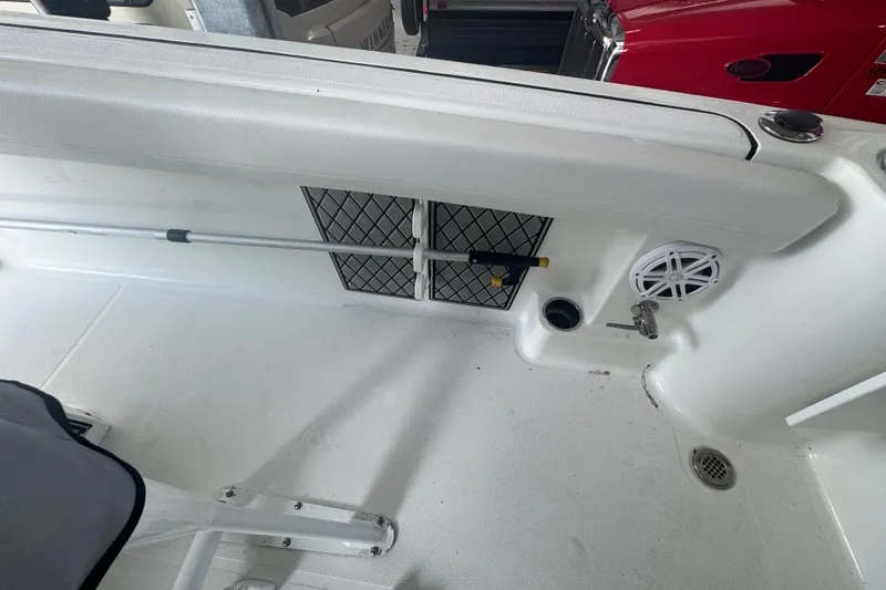 Slide: The Image of 2023 Wellcraft 242 Fisherman boat interior with storage net, speaker, and rod holder. - 27