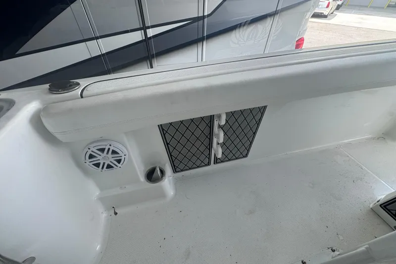 Slide: The Image of 2023 Wellcraft 242 Fisherman boat interior with speaker and storage compartments. - 28