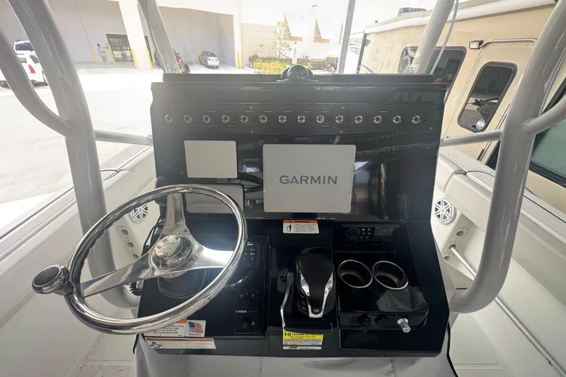 Slide: The Image of 2023 Wellcraft 242 Fisherman dashboard with Garmin display and steering wheel. - 29