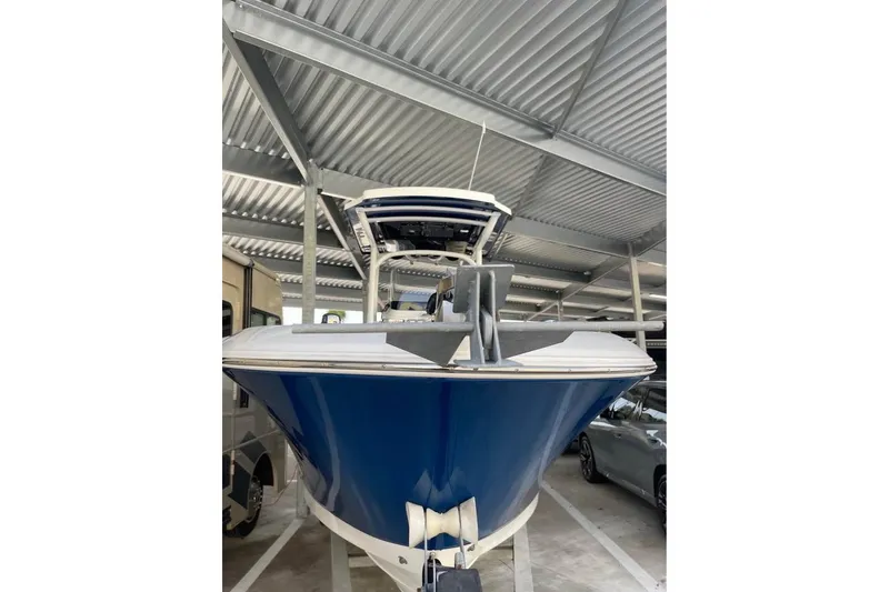 Slide: The Image of 2023 Wellcraft 242 Fisherman boat with Scarab Offshore logo on trailer. - 3