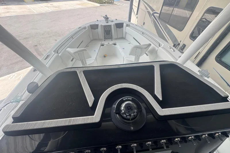 Slide: The Image of 2023 Wellcraft 242 Fisherman boat interior with compass and seating area. - 30