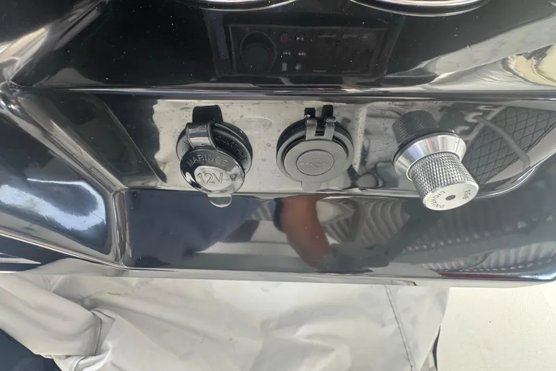 Slide: The Image of Control panel of 2023 Wellcraft 242 Fisherman boat with 12V socket and lighting knob. - 35