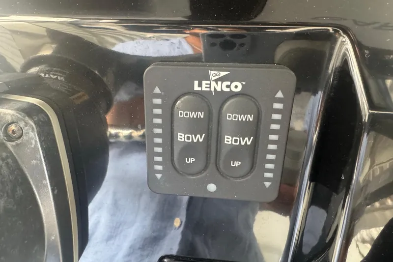 Slide: The Image of Lenco trim tab control panel on 2023 Wellcraft 242 Fisherman boat dashboard. - 36