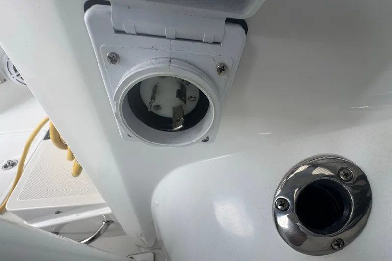 Slide: The Image of 2023 Wellcraft 242 Fisherman boat electrical outlet and port detail. - 38
